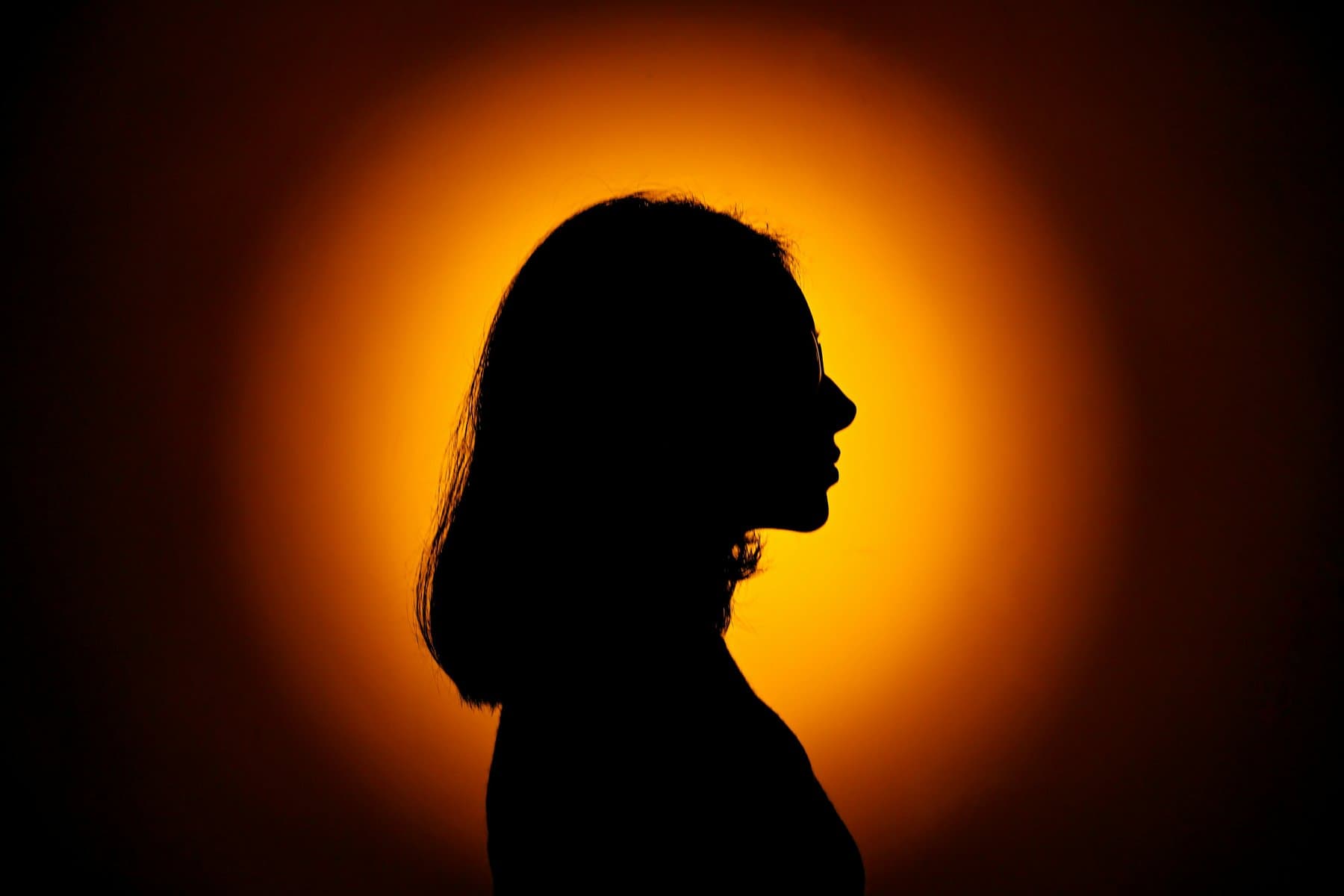 Woman silhouette against orange background